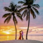 Saint Lucia Caribbean Island, couple watching sunset under a palm tree