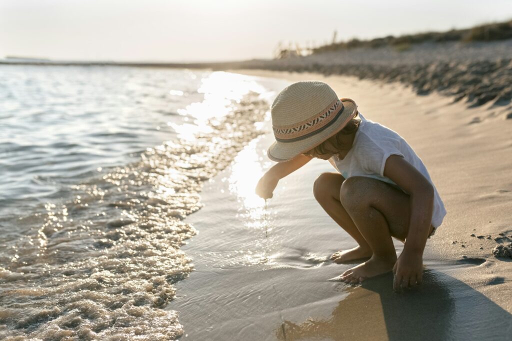 Spain, Menorca, little girl playing on the beach