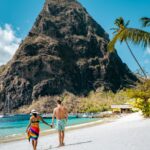 St Lucia couple walking on the beach during vacation Sugar beach Island of Saint Lucia Caribbean