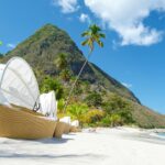 Sugar beach Saint Lucia ,white tropical beach palm trees and luxury beach chairs St Lucia Caribbean
